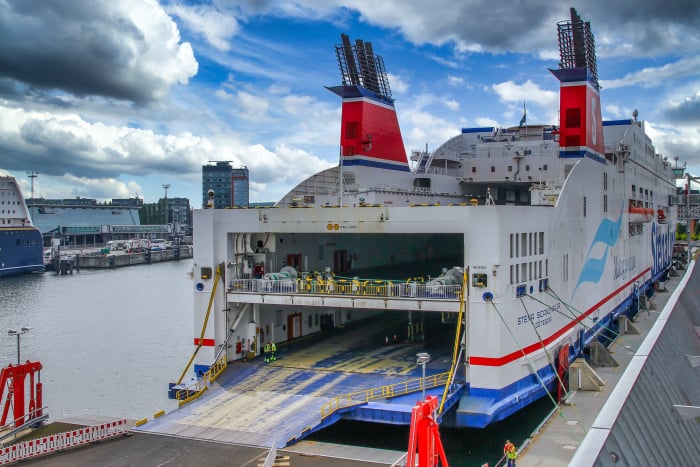 Rückansicht eines Fährschiffes mit geöffneter Ladeklappe für Fahrzeuge auf zwei Decks.